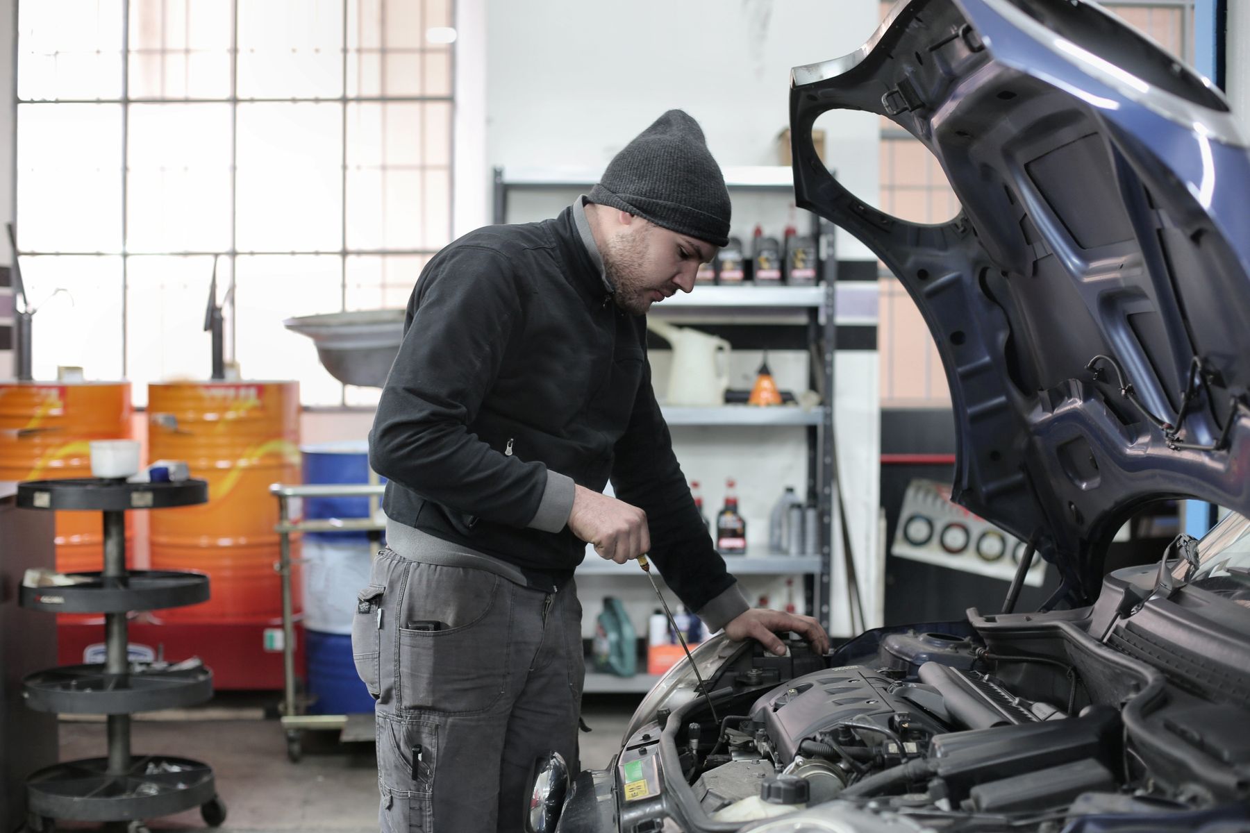 Technician inspecting the engine of a used vehicle