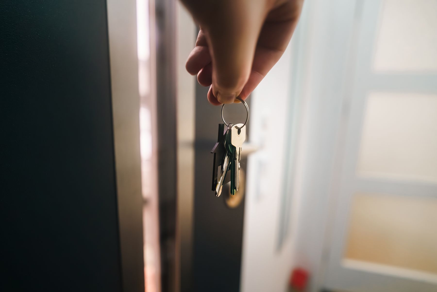 House keys held at the entrance to a home